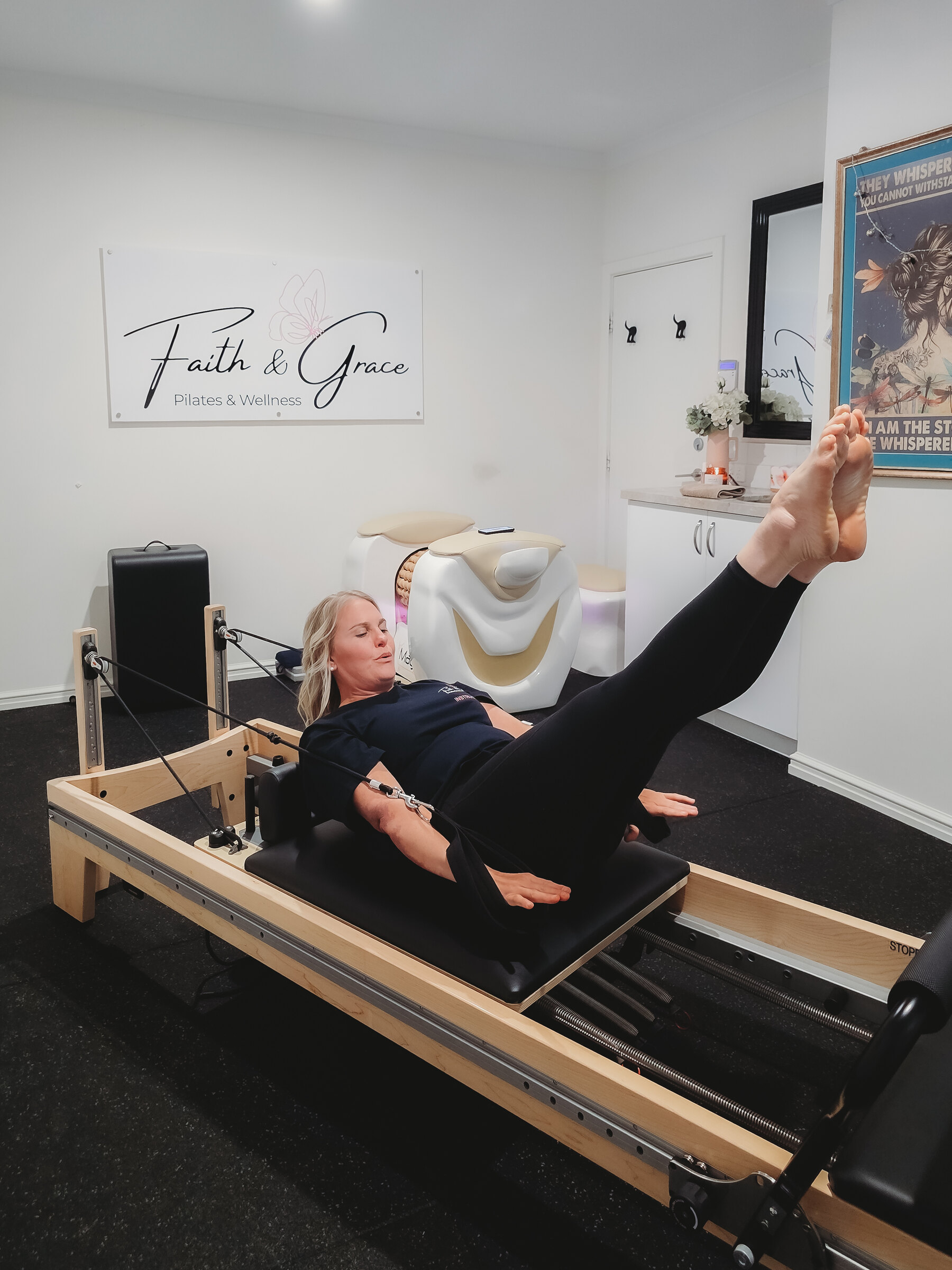Jenelle demonstrating a reformer Pilates exercise in the studio