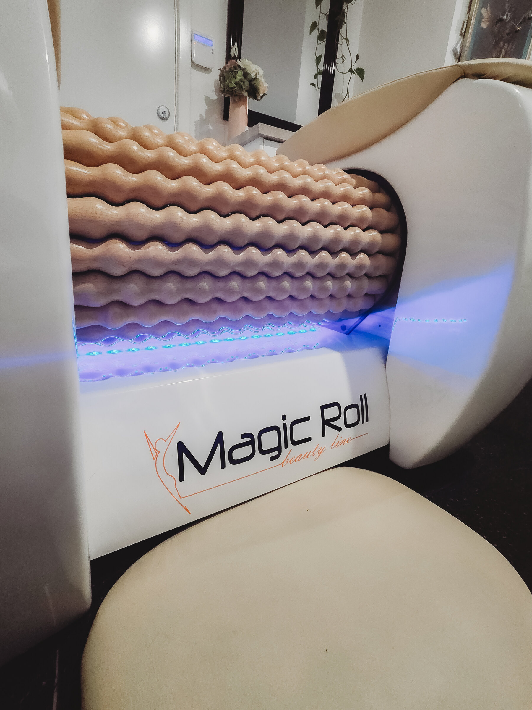 Close-up of the Magic Roll wooden roller machine with its lights on
